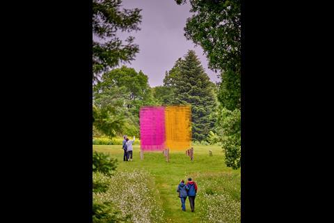 Colourful abstract art piece surrounded by trees